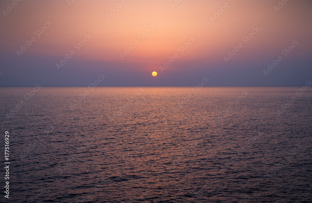 Brightly colored sunset over the calm Mediterranean Sea. Drone Point of View . Night Brightly colored sunset over the calm Mediterranean Sea. Drone Point of View . Night