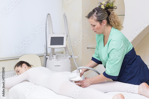 Woman is in the process at the clinic lipomassage 