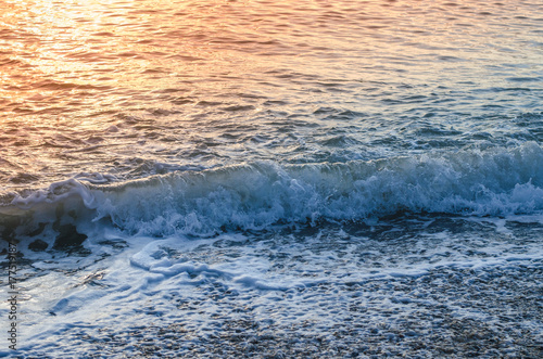 Sea surface, wave and sunset light