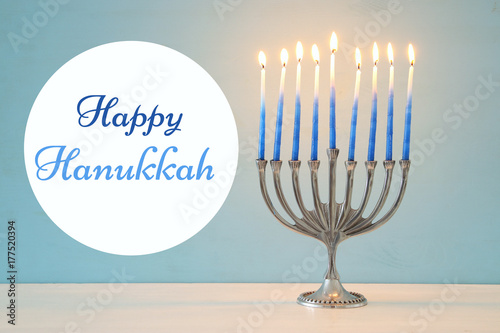 image of jewish holiday Hanukkah background with traditional menorah (traditional candelabra) and burning candles