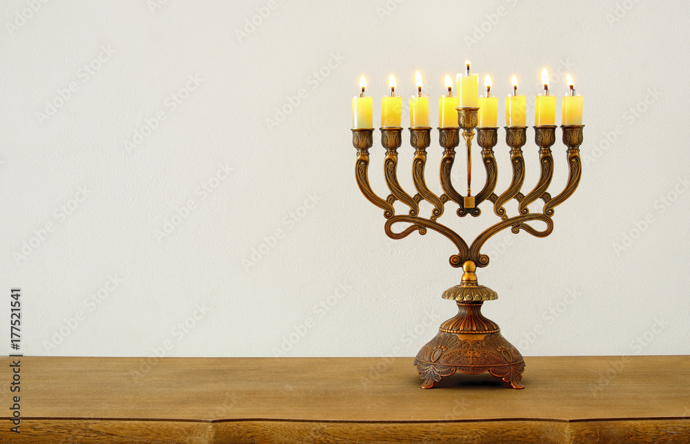 Image of jewish holiday Hanukkah background with menorah (traditional candelabra) and burning candles Image of jewish holiday Hanukkah background with menorah (traditional candelabra) and burning candles