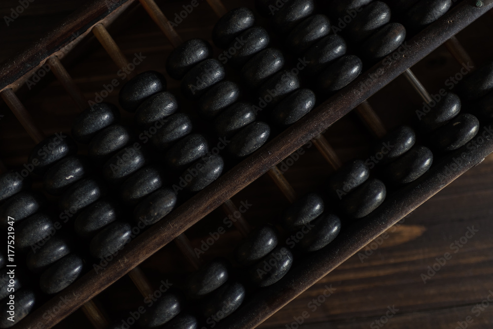 Old abacus on a wooden floor in the dark Old abacus on a wooden floor in the dark