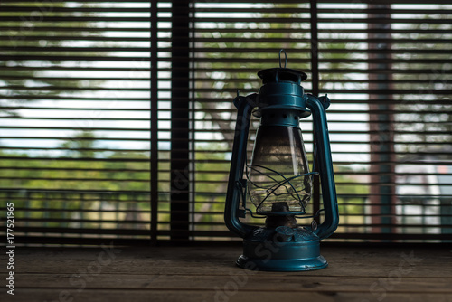 Old blue lamp in the office on the wooden floor.