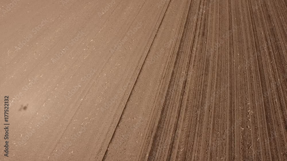 Aerial shot of a farmer seeding, sowing crops at field. Aerial shot of a farmer seeding, sowing crops at field.