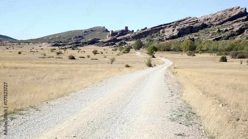 landscape with a country road and the Castle of Zafra in Campillo de Duenas, Province of Guadalajara, Spain landscape with a country road and the Castle of Zafra in Campillo de Duenas, Province of Guadalajara, Spain