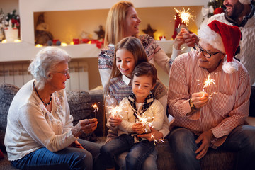 Grandparents with children celebrating New Year