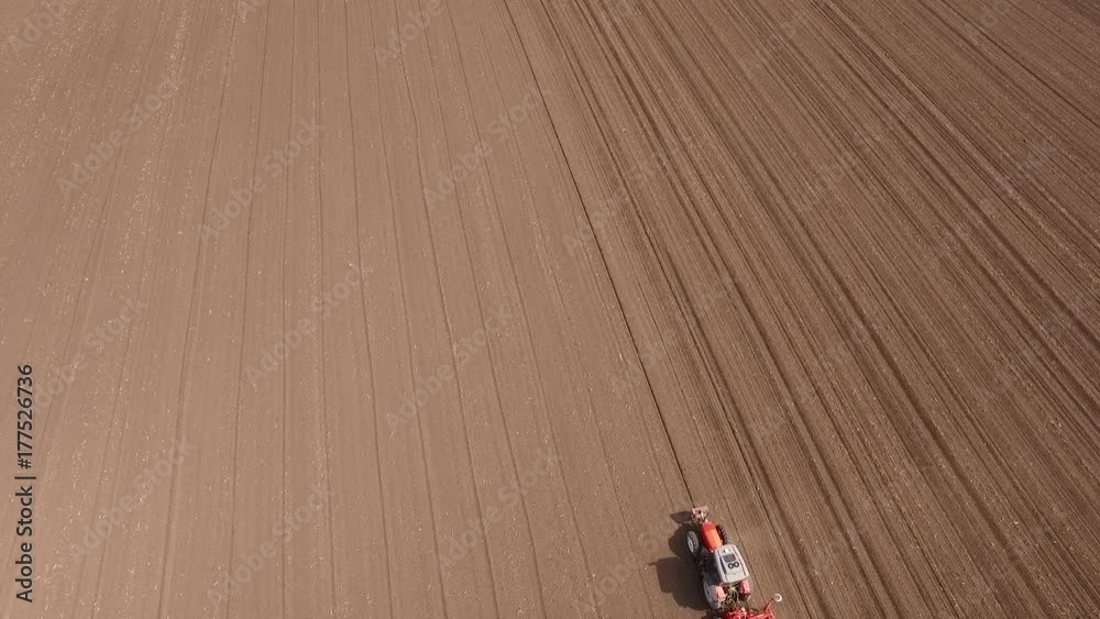 Aerial shot of a farmer seeding, sowing crops at field. Aerial shot of a farmer seeding, sowing crops at field.