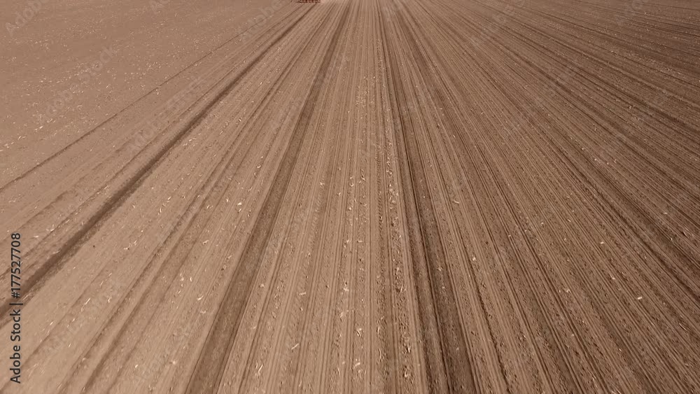 Aerial shot of a farmer seeding, sowing crops at field. Aerial shot of a farmer seeding, sowing crops at field.