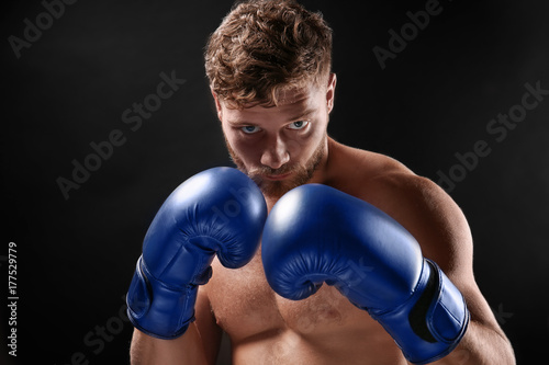 Male boxer on dark background