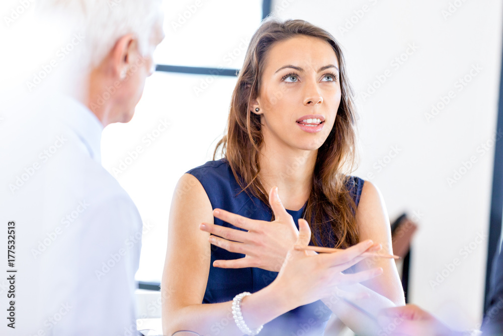 Young businesswoman sitting at desk and working Young businesswoman sitting at desk and working