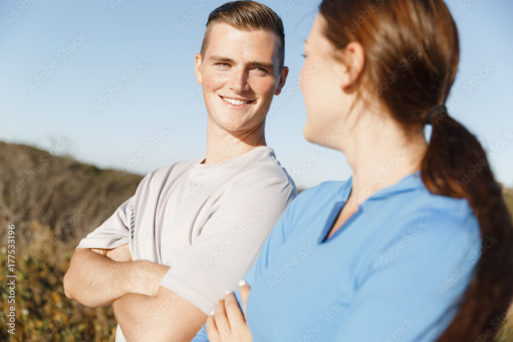 Young couple on beach training together Young couple on beach training together