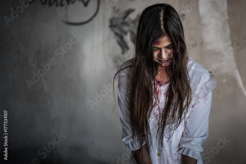 Portrait zombie woman with blood on face