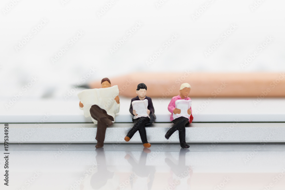 Miniature people sitting on keyboard using as background education or business concept. Miniature people sitting on keyboard using as background education or business concept.