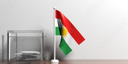 Foto Kurdistan flag next to a glass ballot box on wooden surface