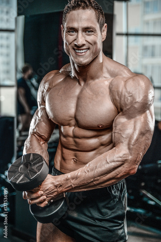 Brutal Caucasian bodybuilder working out in gym