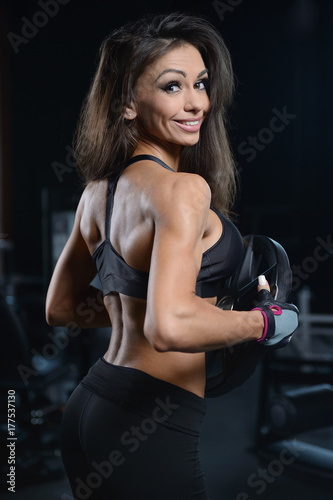 Sexy athletic young girl working out in gym