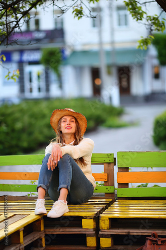 Inspired woman sitting on bench, street lifestyle, outdoor