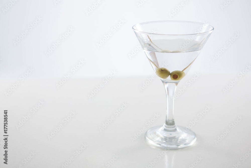 Cocktail martini with olives on table Cocktail martini with olives on table
