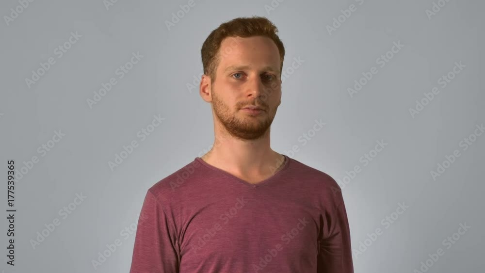caucasian guy with red hair take off eyeglasses. handsome redhead men wearing in casual t-shirt. smart young caucasian man on grey background caucasian guy with red hair take off eyeglasses. handsome redhead men wearing in casual t-shirt. smart young caucasian man on grey background