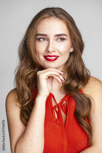 Portrait of a young beautiful woman in a red blouse
