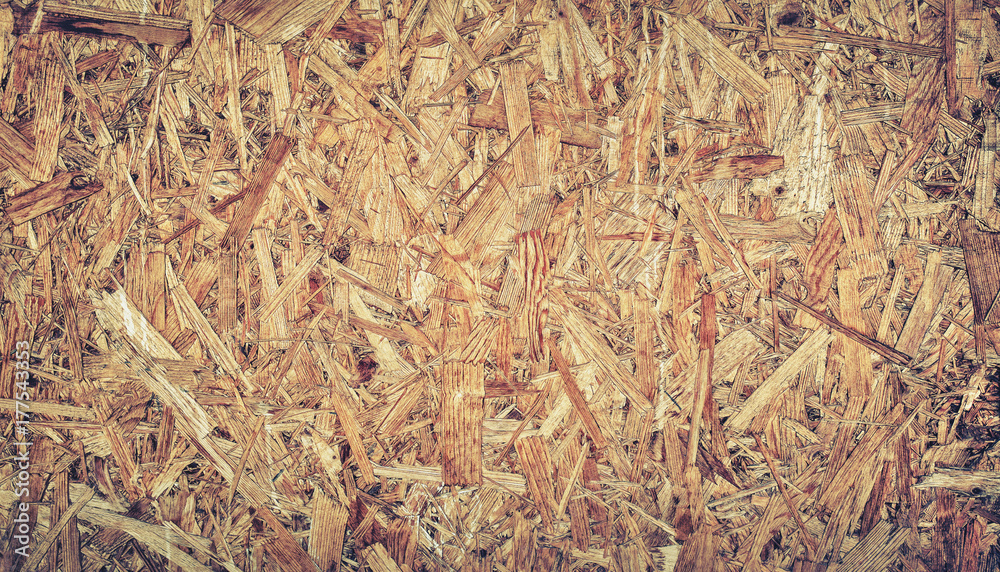 close up pressed wooden panel background, seamless texture of oriented strand board - OSB wood