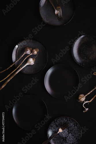 Simple modern kitchen still life in black ceramic plate dry garlic