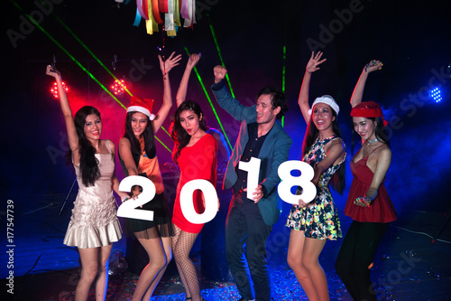 Group of people dancing at night club with santa hat christmas holidays party friendship relaxing celebrating new year 2018..