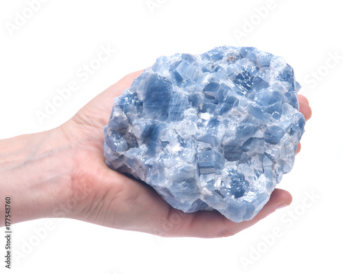  Woman's hand holding raw blue calcite cluster isolated on white background