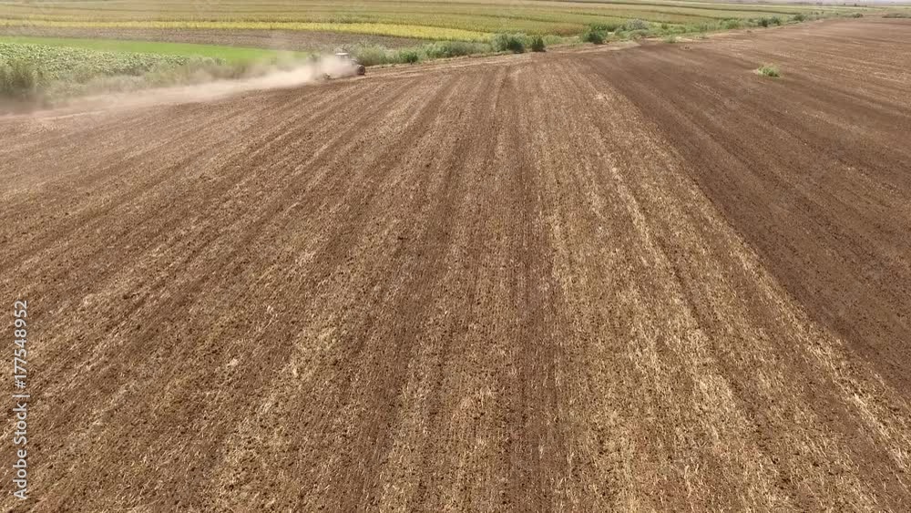 Aerial view of tractor cultivating wheat stubble field Aerial view of tractor cultivating wheat stubble field