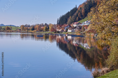 All Hopfensee reflecting the village homes along the water 
