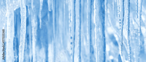 Natural winter bright background of shiny icicles