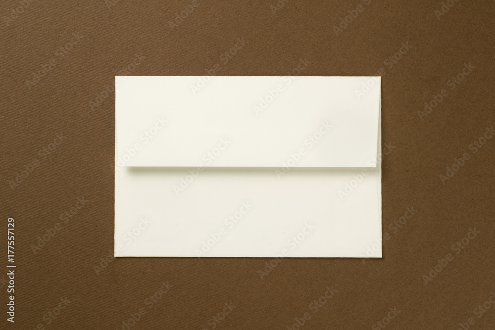 Envelope and postcard on brown backgroun Envelope and postcard on brown backgroun