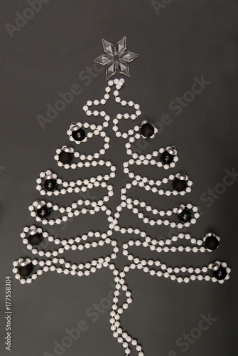 symbolic New Year's tree, New-year tree, white beads are on black background, post card