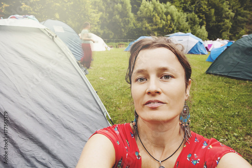 Young woman traveling and sleeping in tent photo