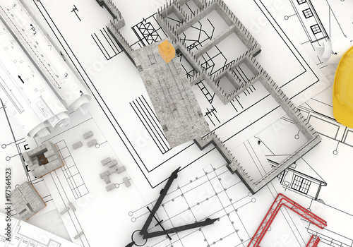 foundation under construction with crane, on top of blueprints photo