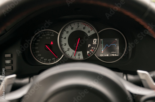 Dashbord of the sports car with tachometer and speedometer.