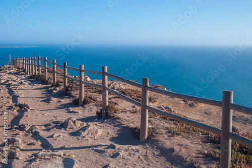 View od Cabo da Roca in Sintra - Roca Cape - cliffs and fence at sunset