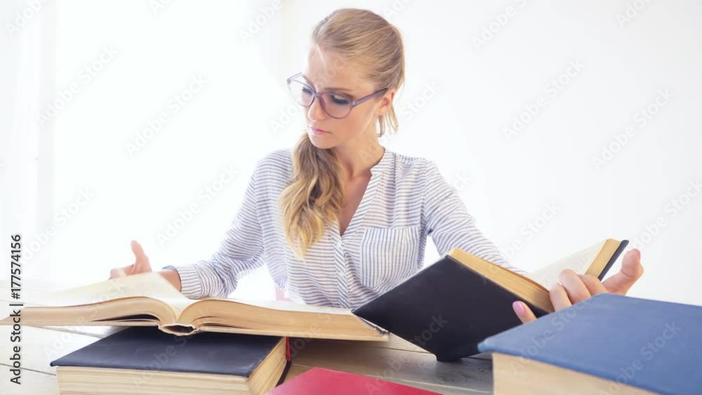 business girl sits in the Office paper folders Secretary reads books business girl sits in the Office paper folders Secretary reads books
