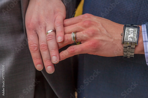 male hands and wedding rings from gay wedding
