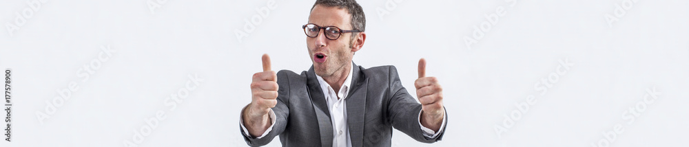 happy middle aged businessman with eyeglasses and thumbs up, panoramic view happy middle aged businessman with eyeglasses and thumbs up, panoramic view