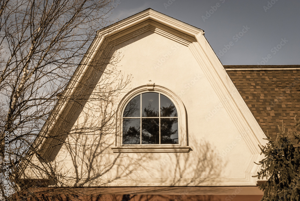 Arched roof with isolated window. Building with curved gable roof