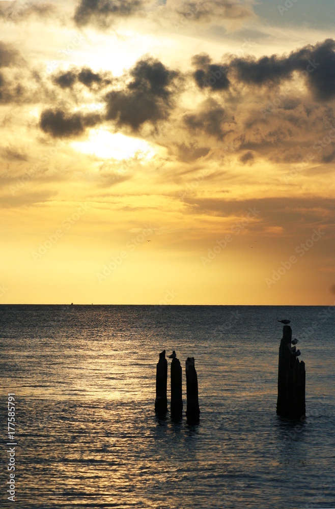 Rays of sunlight through the clouds over the water