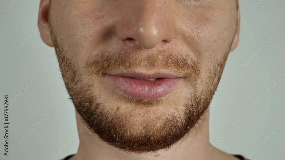 close up part of face young caucasian man with beard and bristle