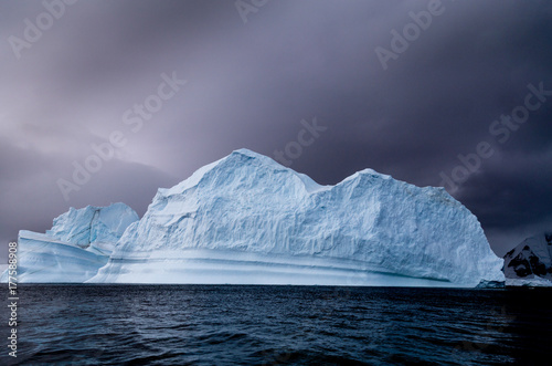 An iceberg that has started to melt, dark background