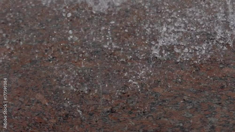 Fountain Rain Drops. Slow movement of the surface of the water splashes a river or pond. Heavy rain or working fountain. Drops of water fall down the macromolecule Fountain Rain Drops. Slow movement of the surface of the water splashes a river or pond. Heavy rain or working fountain. Drops of water fall down the macromolecule