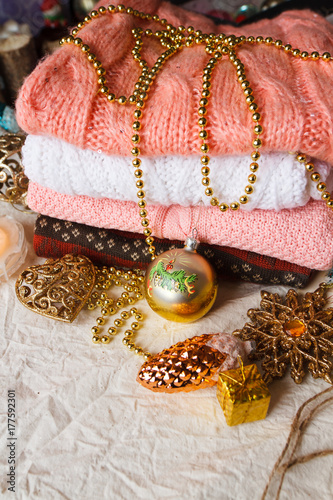 Christmas toys and a stack of knitted sweaters photo