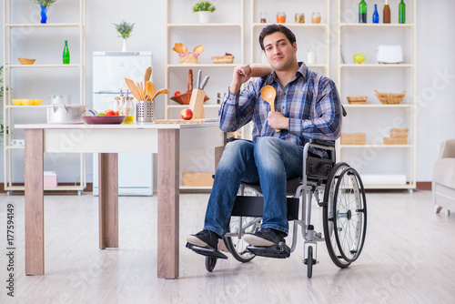Disabled young man husband workin in kitchen © Elnur