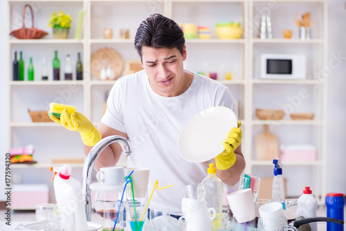 Man frustrated at having to wash dishes