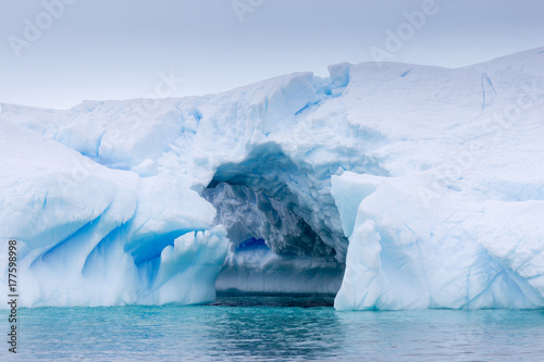 A huge cave has been carved in tho this iceberg.