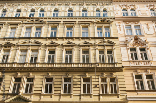 Traditional facade of buildings, exterior of buildings in Prague. Close-up of beautiful historic buildings standing tightly together